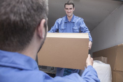Local house removals team working in Colliers Wood street with moving van