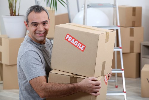Removal van and moving team preparing a local house move in Colliers Wood