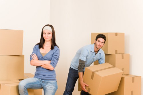 Moving team handling furniture with safety precautions