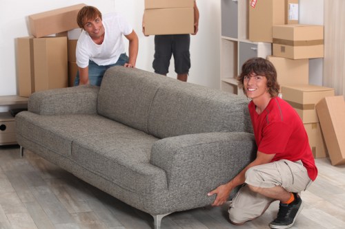 Local movers handling furniture in a Colliers Wood flat